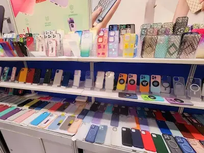 Private label phone case display at a trade fair supplier booth